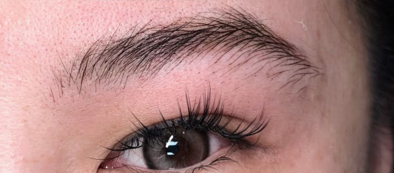 The same brow after the work, in the same crop: individual strokes laid over and past the old shape, the grey no longer readable underneath.