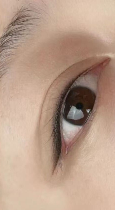 The same eye after the work: a defined line along the lash line that thickens toward the outer corner.