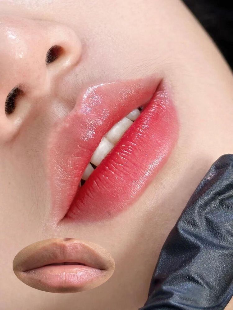 After: red lips that soften toward the border, the artist's gloved hand in frame. The small oval photo shows the lips before: light, with a browner upper lip and darker corners.