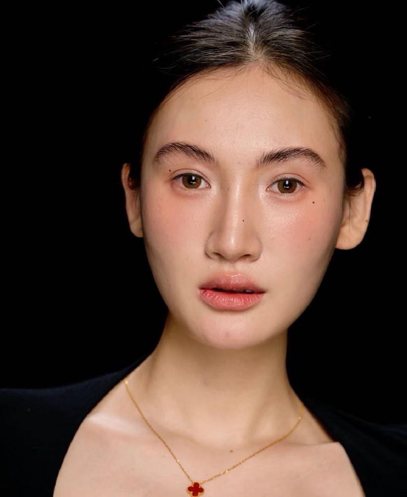The finished brows only, in a portrait on a black ground: full, natural and softly defined.