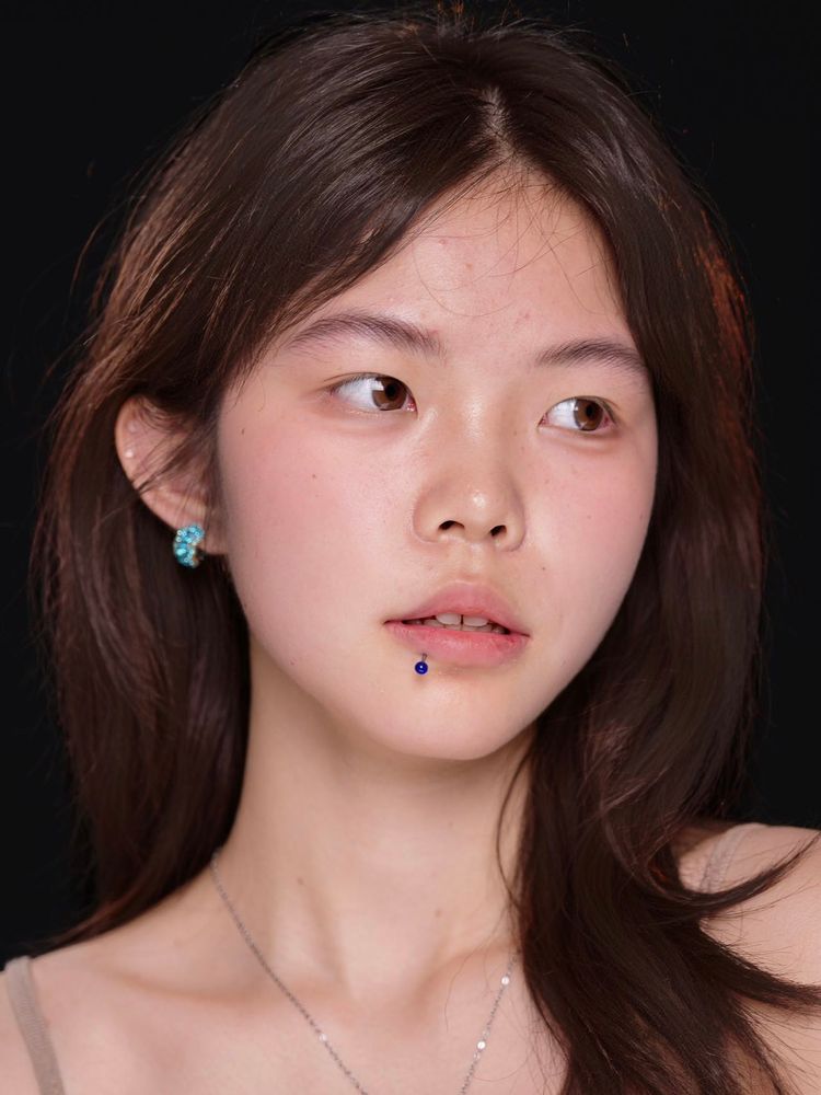 The finished brows only, in a portrait on a black ground: soft and natural.